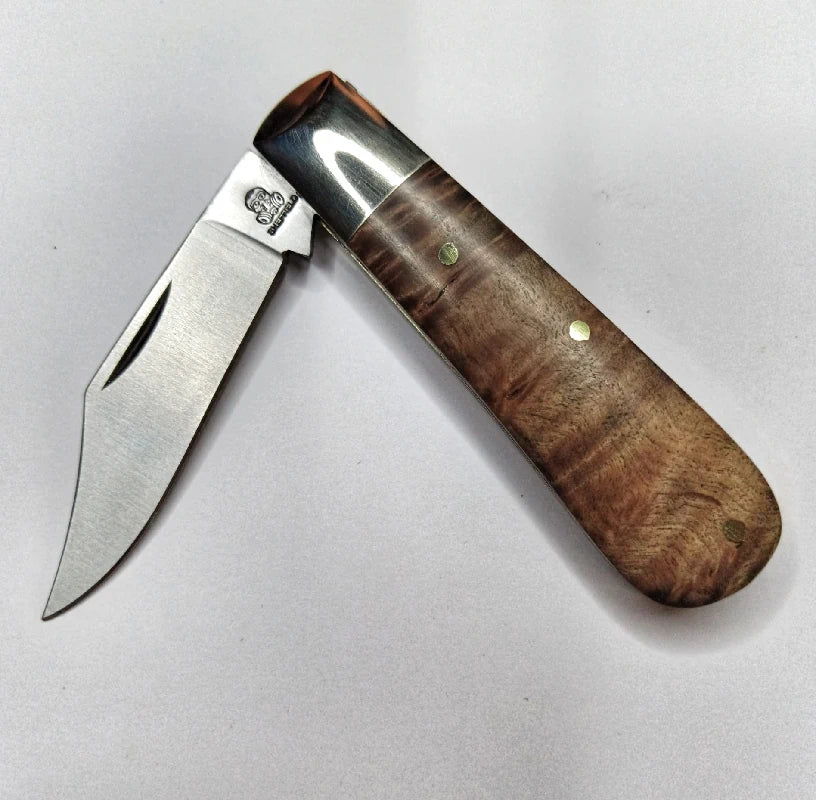 A traditional Sheffield made clip point barlow pocket knife with maple burl scales.